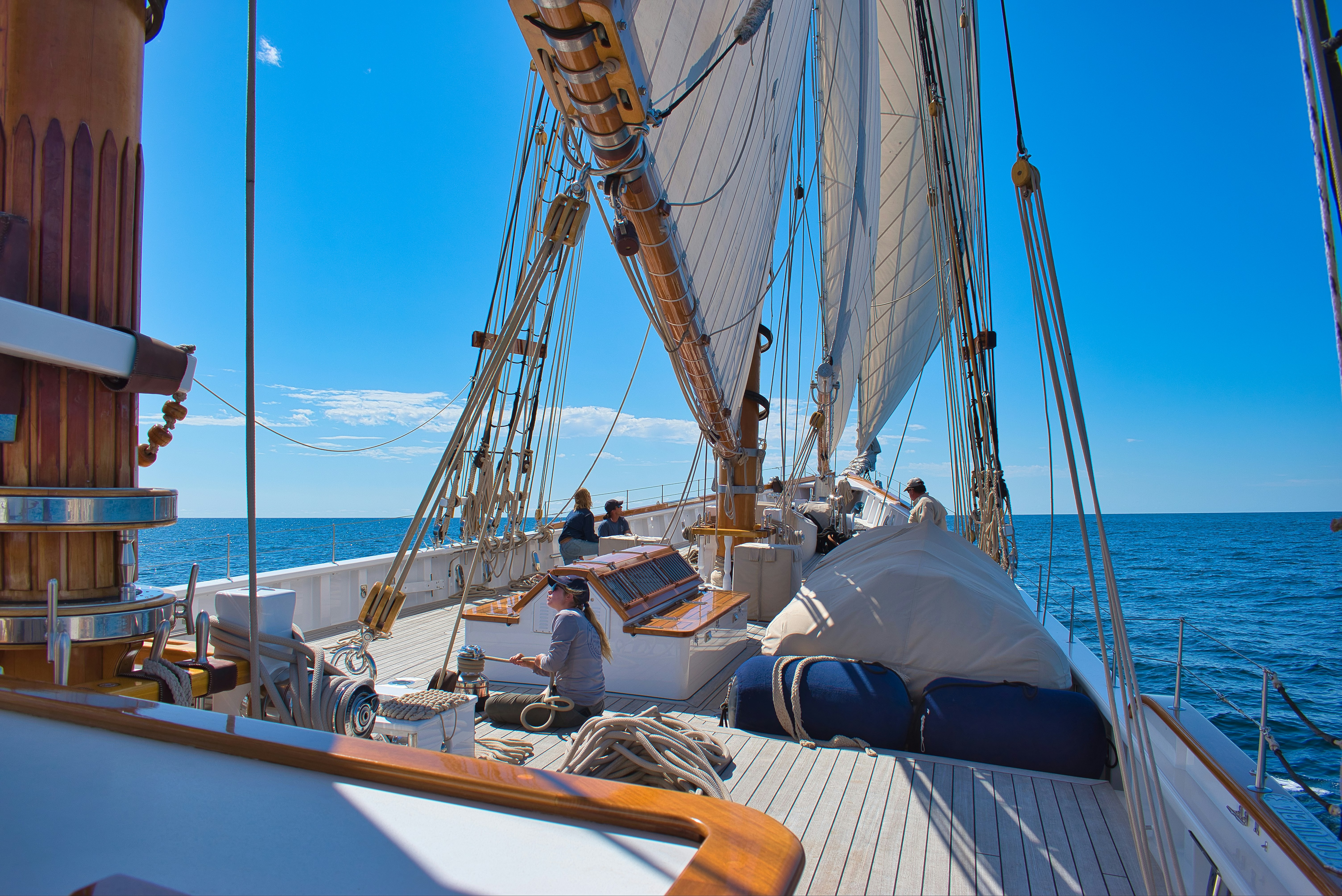 Sailing yacht deck with lounge seating at sea