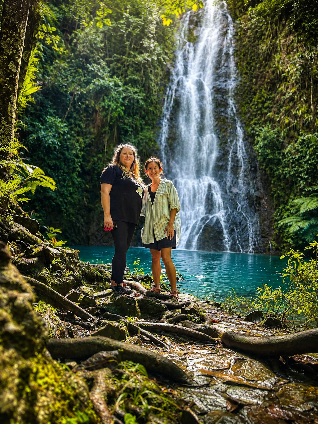 Karyn and Tanitra hiking to a waterfall in Belize