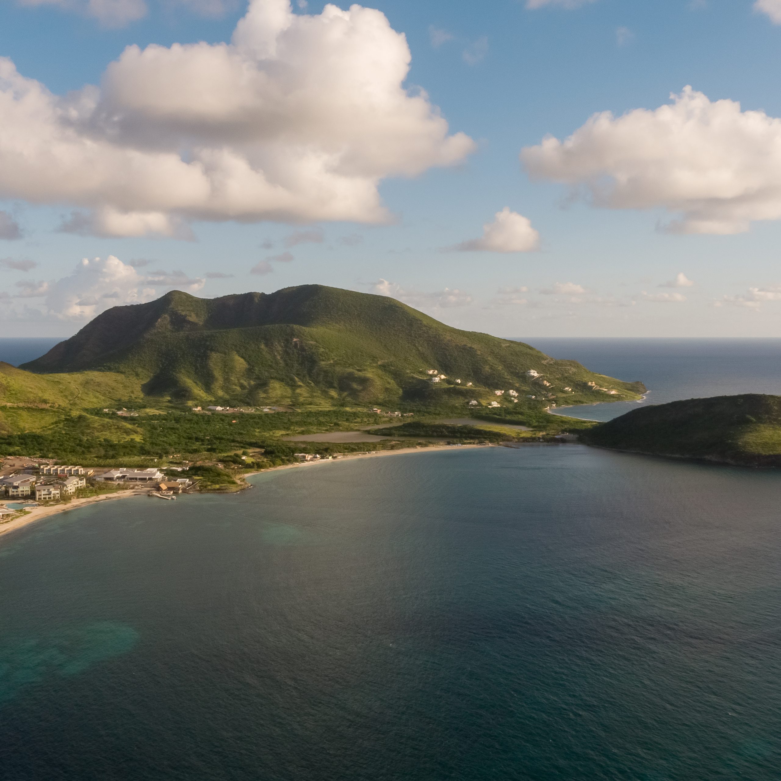 Park Hyatt St Kitts aerial view — Christophe Harbour luxury resort on Caribbean coastline with Nevis mountain backdrop