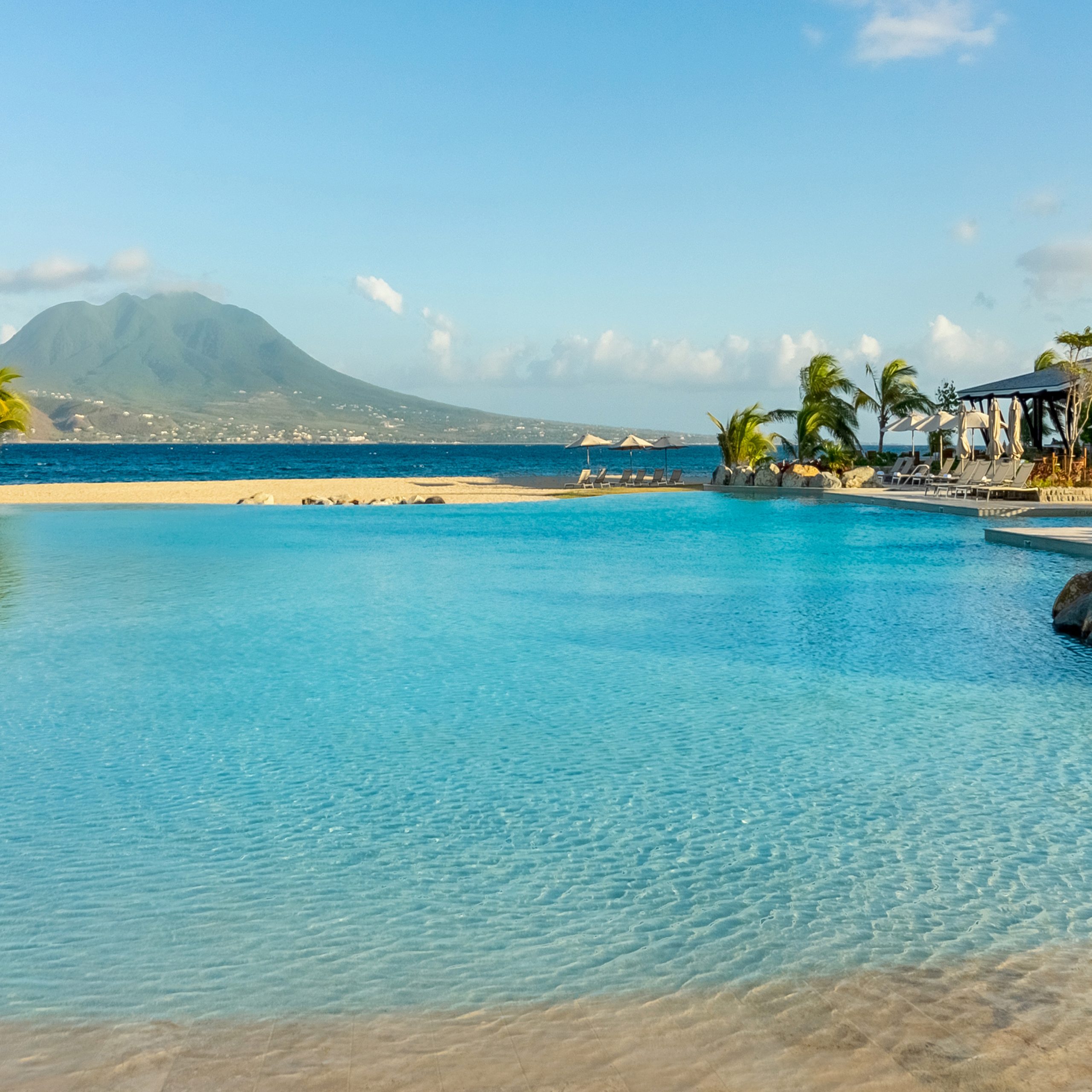 Park Hyatt St Kitts Christophe Harbour — lagoon pool with turquoise Caribbean waters and Nevis mountain views, luxury resort Caribbean
