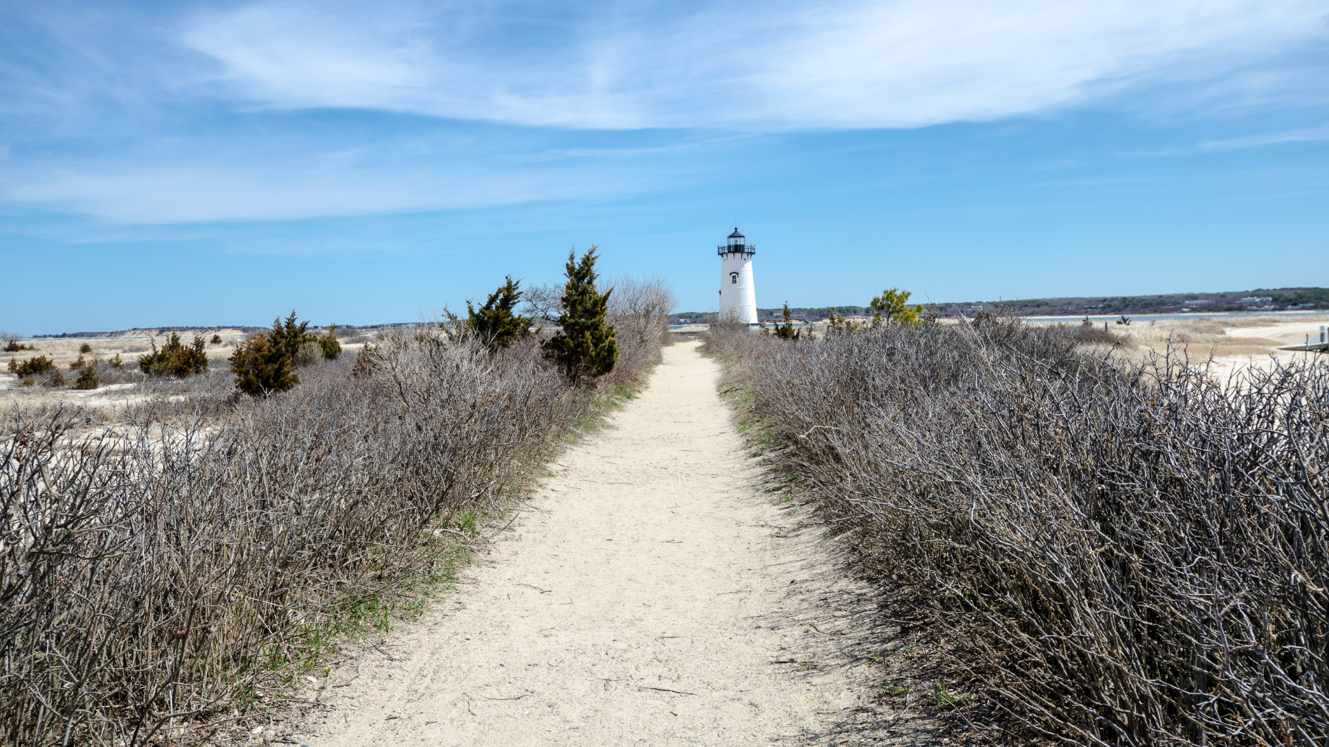 Sandy path leading to Edgartown lighthouse Martha's Vineyard on a clear blue sky day — Sirena Collective