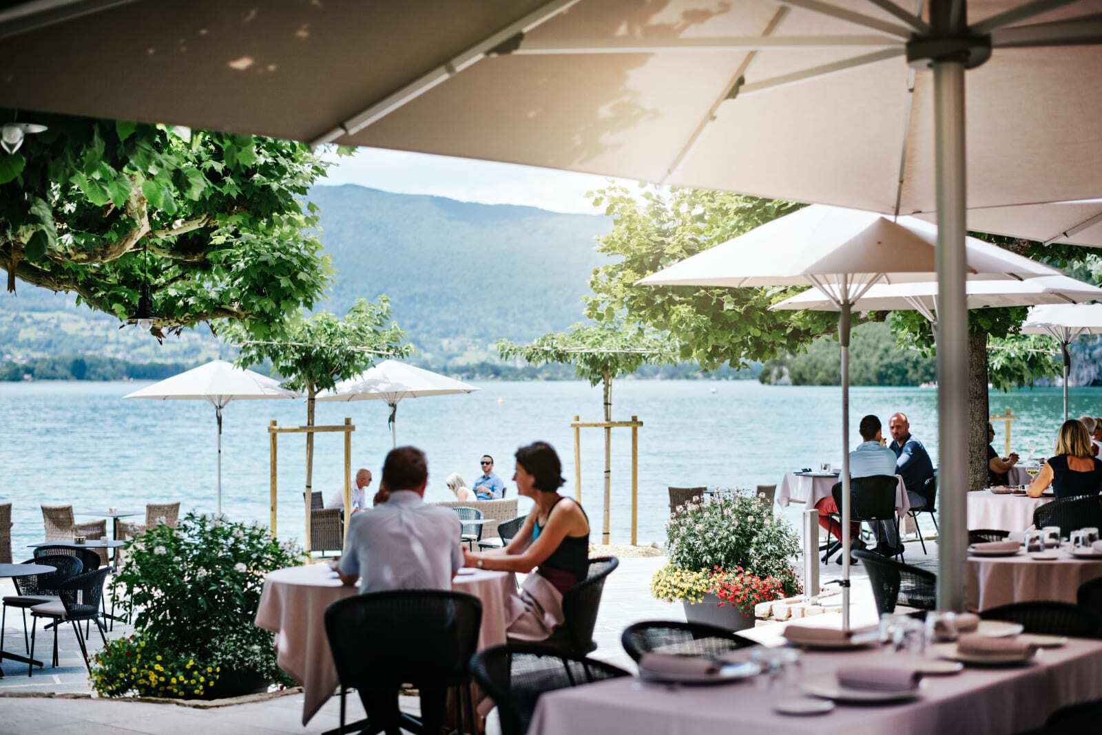 Lakeside outdoor dining terrace at Auberge du Père Bise on Lake Annecy