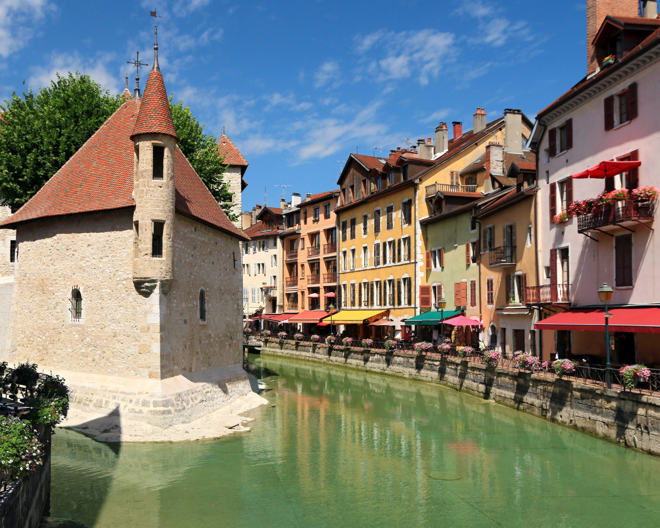Annecy old town canal lined with historic buildings and flower boxes