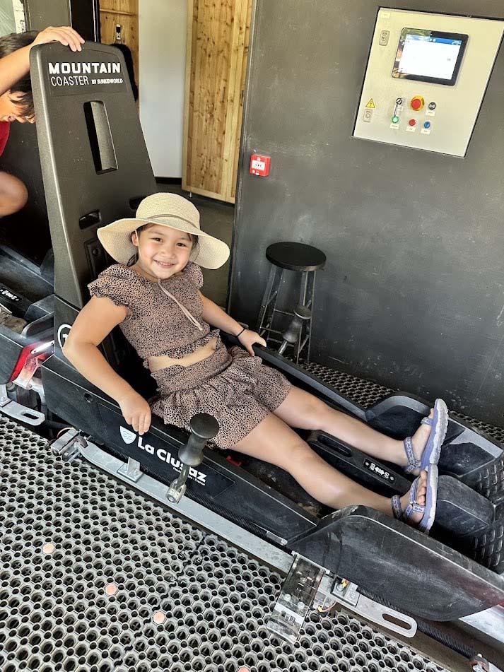 Child enjoying the Luge des Bois summer toboggan ride in La Clusaz