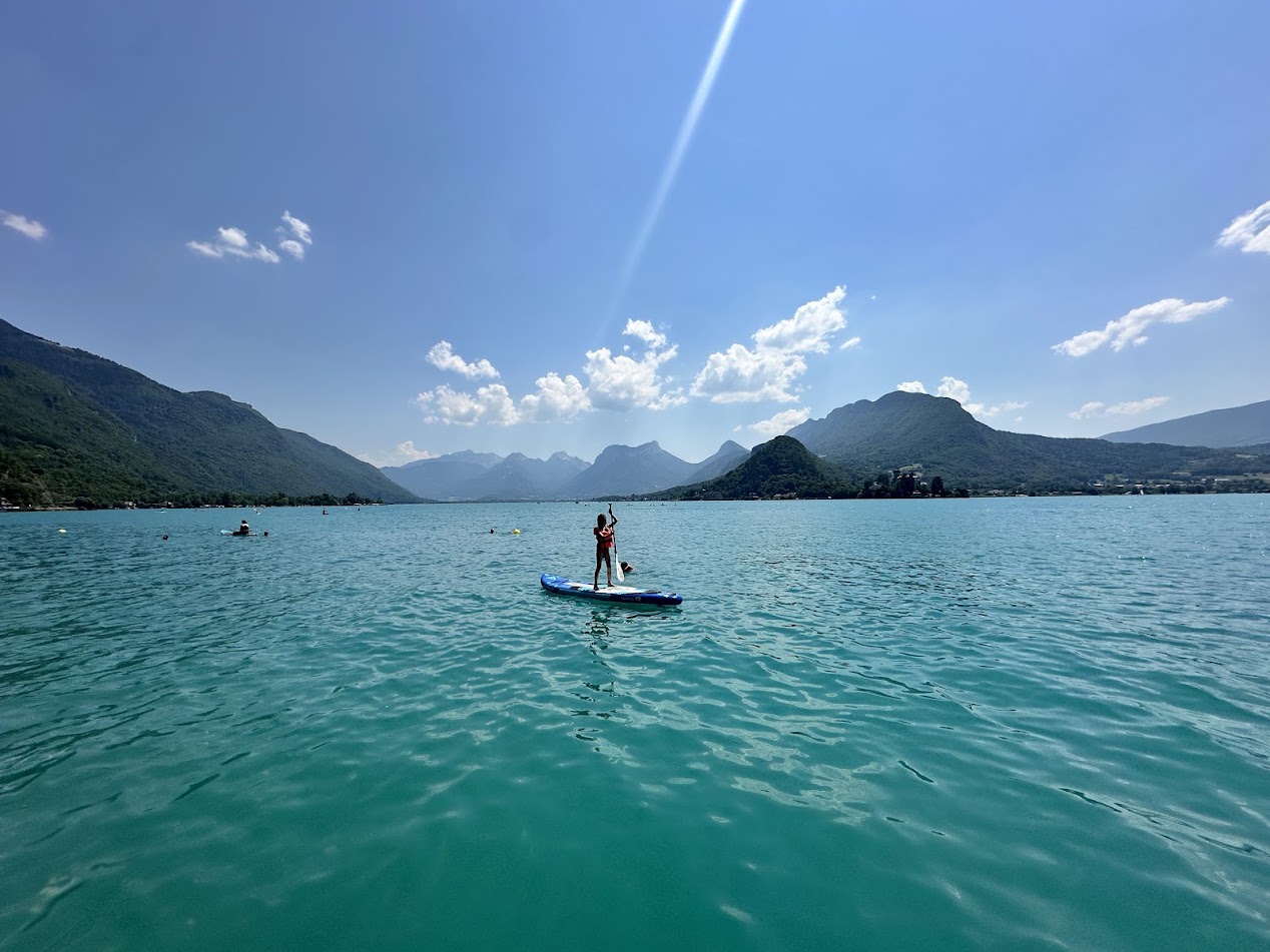 Stand-up paddleboarding on the turquoise waters of Lac d'Annecy in France