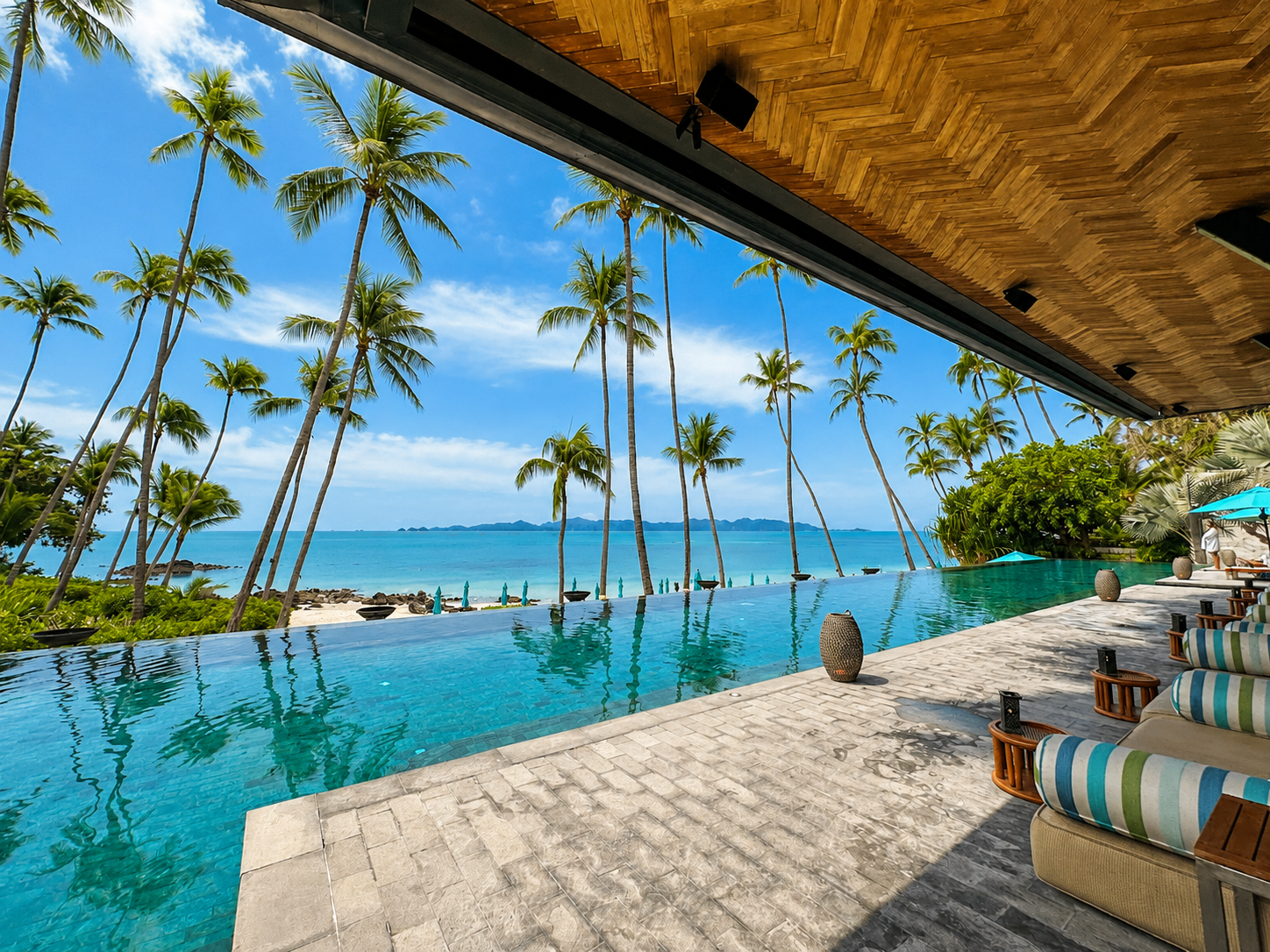 Four Seasons Resort Koh Samui main infinity pool surrounded by palm trees and ocean views